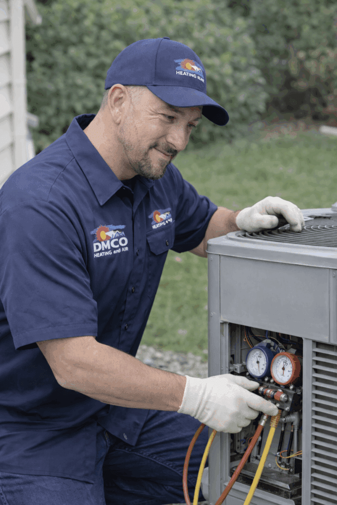 HVAC technician checking outdoor air conditioner gauges